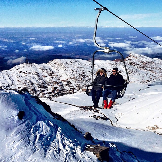 Tourists riding to the top of Oukaimeden, Africa's tallest ski resort. The chairlift rises to 3,258 meters and you can see #Marrakesh in the distance. #Morocco #travel #ski #Africa #Oukaimeden