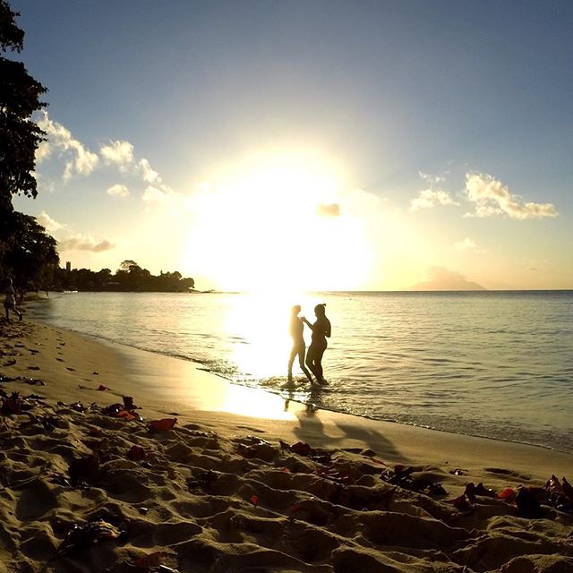 Two girls playing on the beach at Beau Vallon. That's Silhouette Island in the distance. #travel #sunset #seychelles