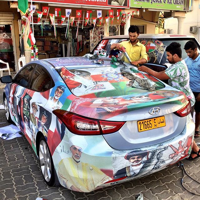 Omanis gearing up for the country's 45th National Day celebrations by plastering their car with pictures of Sultan Qaboos. #Oman